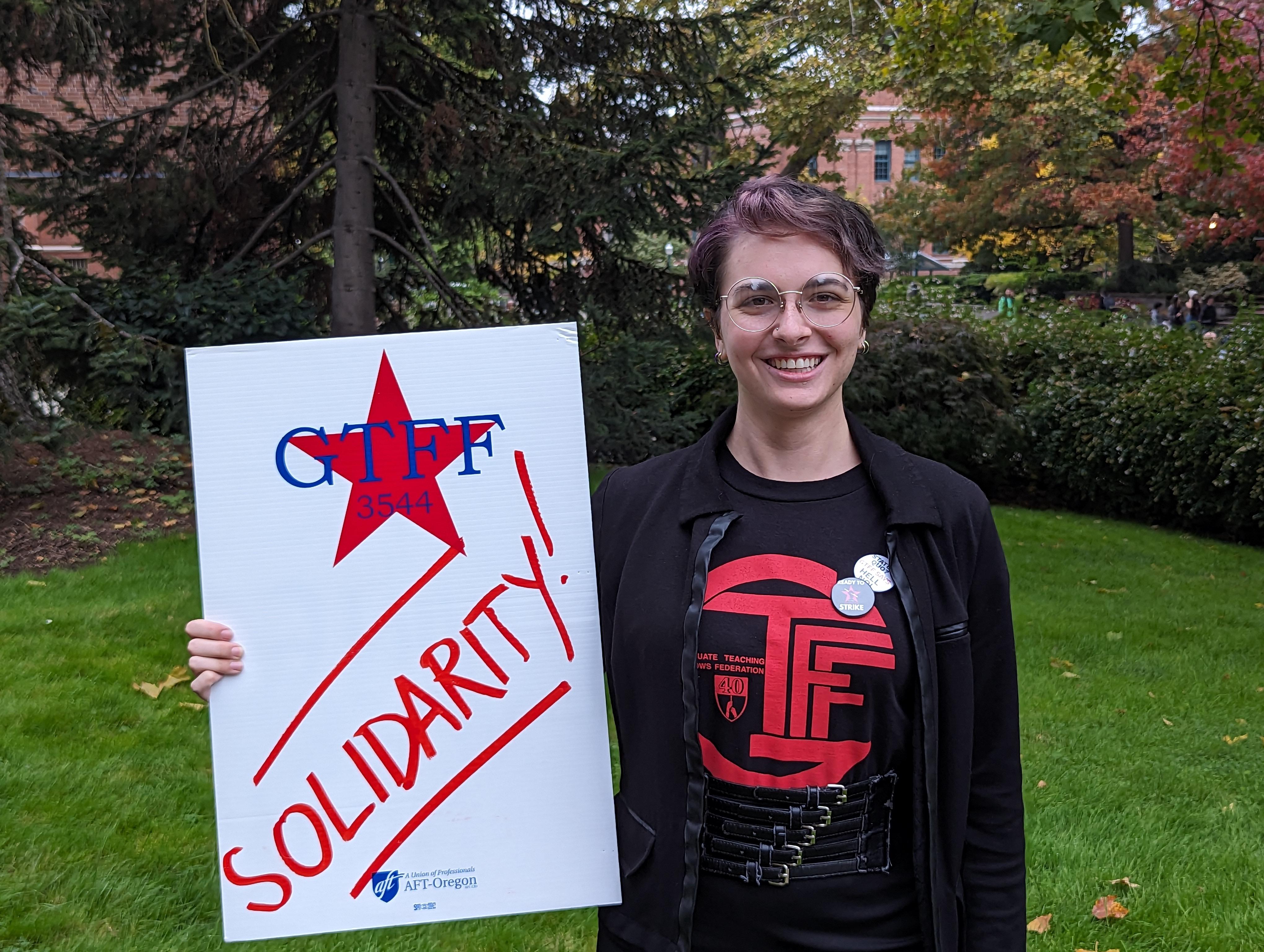 Rocky Penick, General Educator in biology holding a sign with the GTFF Logo &ldquo;Solidarity!&rdquo;