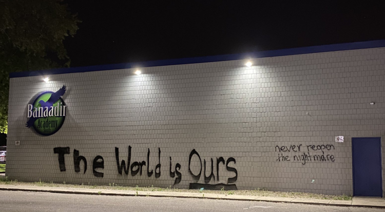 Image of a school in Minnesota with graffiti stating “The World is Ours” and “never reopen this nightmare”