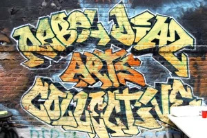 Graffiti of the words &ldquo;Rebel Diaz Arts Collective&rdquo; on a brick wall
