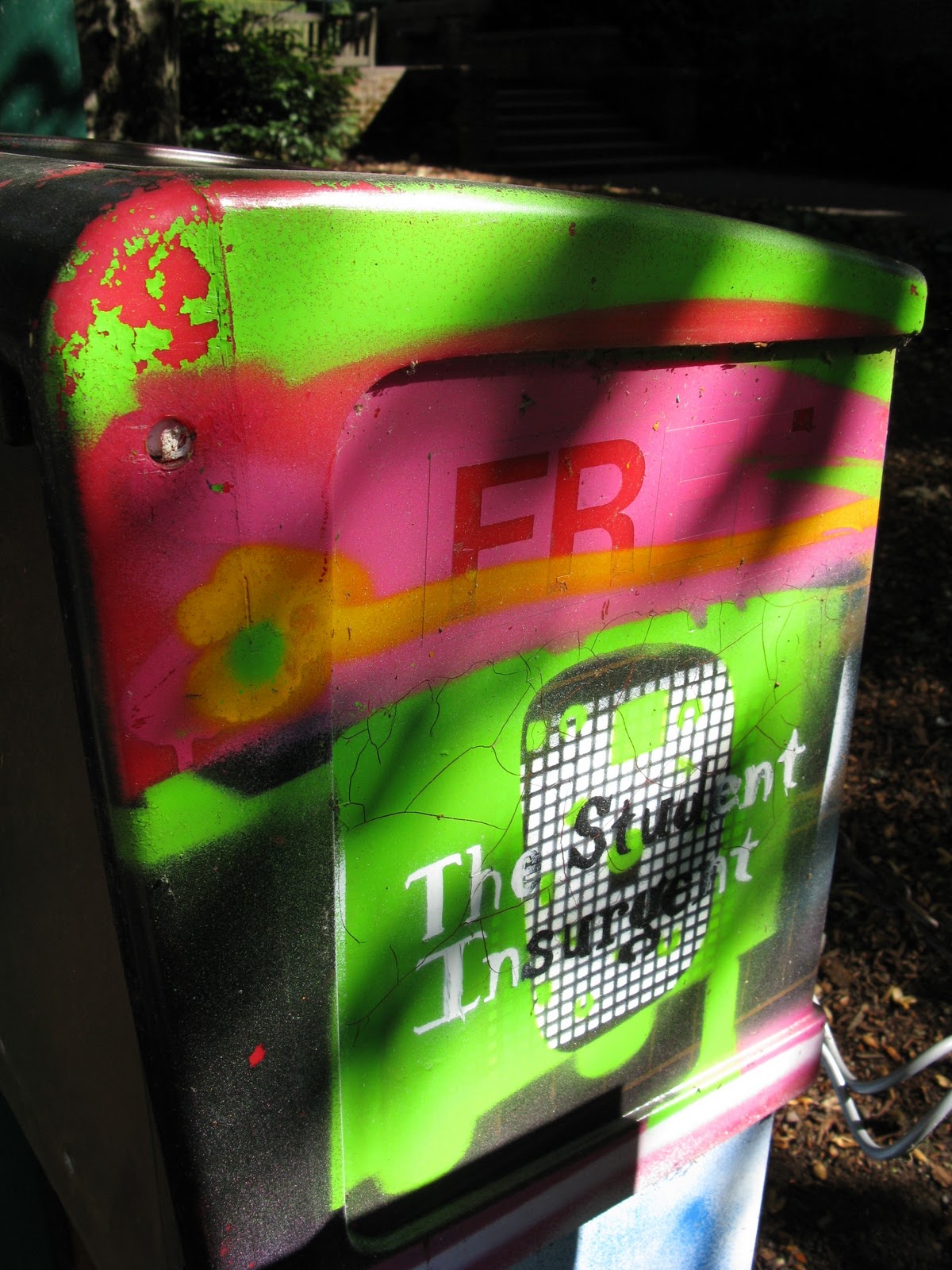 A green and pink dropbox for The Student Insurgent