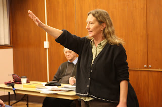 a woman performing a Roman/Nazi salute in the Pacifica Forum